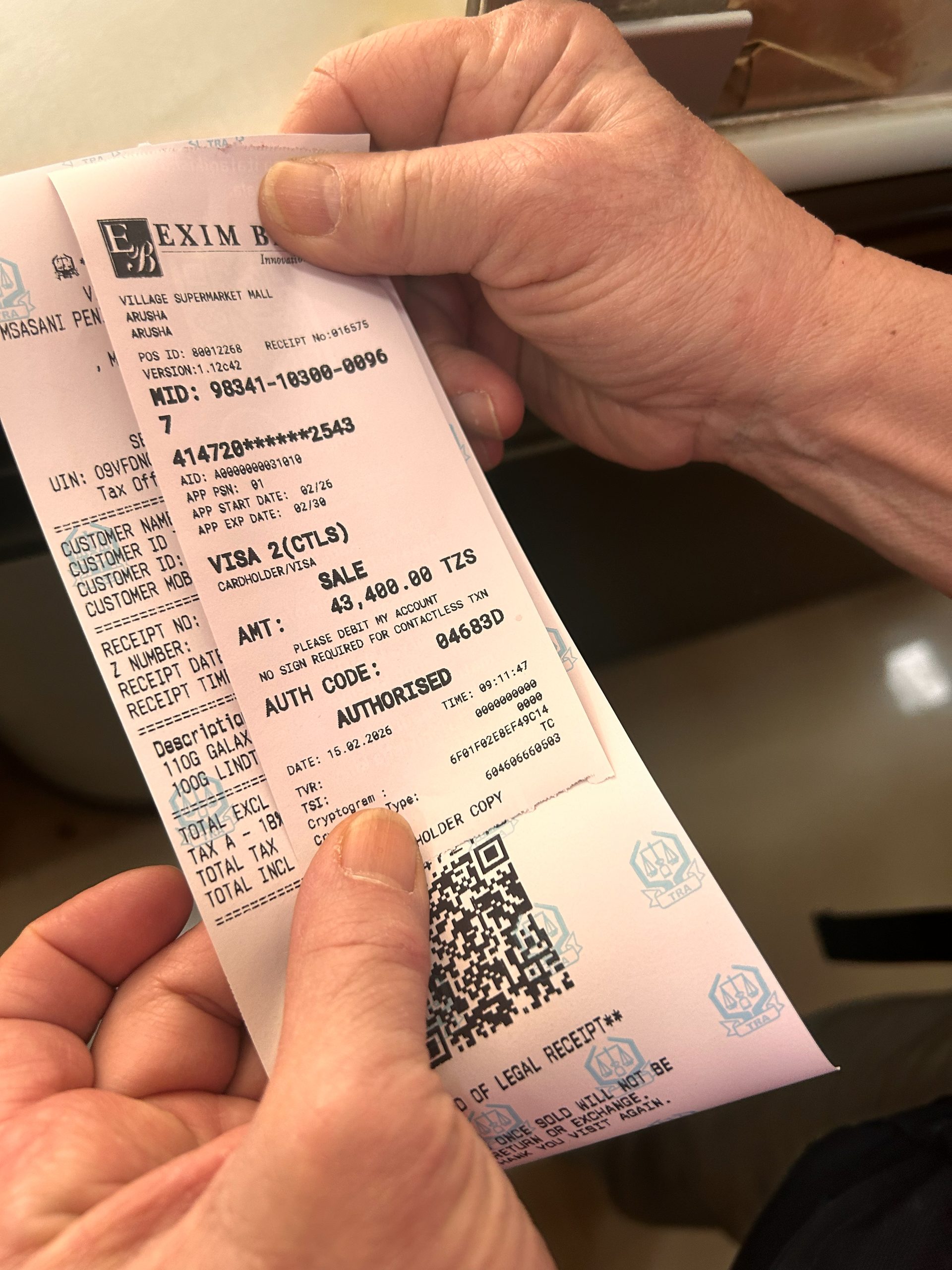 Receipt showing 43,400 TZS — two chocolate bars at the Village Supermarket Mall Arusha